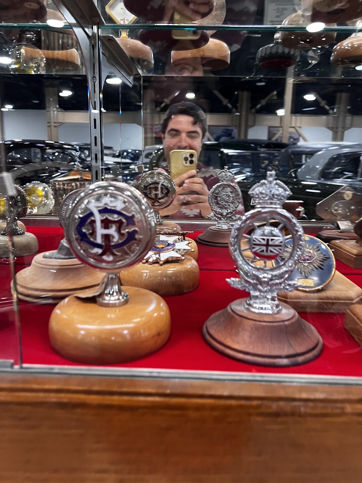 Omar Mukhtar at the Nethercutt Collection near a display of hood ornaments.