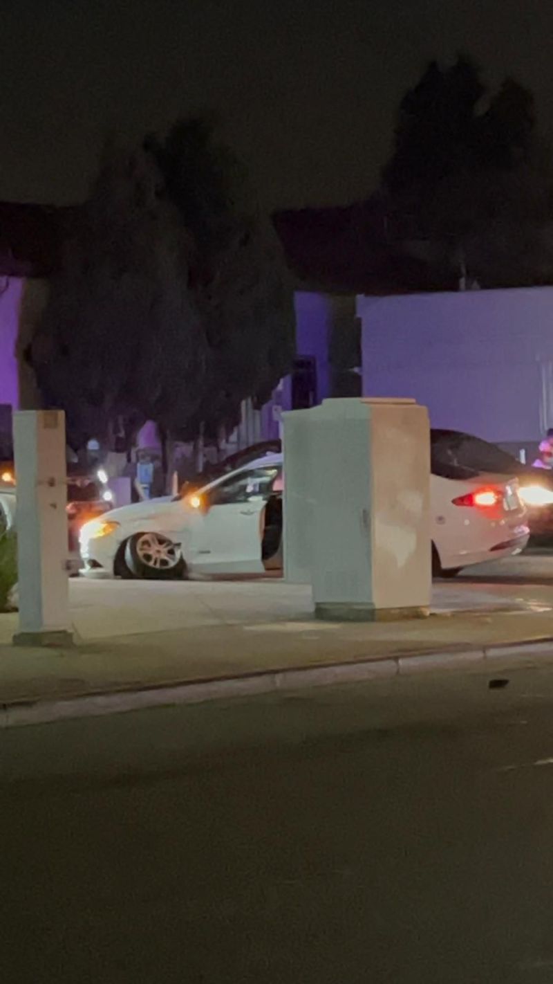 A car stopped on a pedestrian footpath at night after turning off the road
